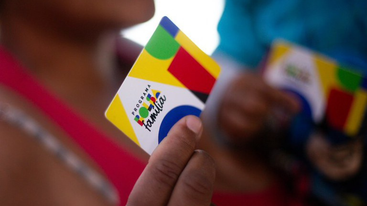 Beneficiária segura cartão do Bolsa Família